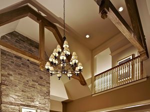 Chandelier hanging between beams