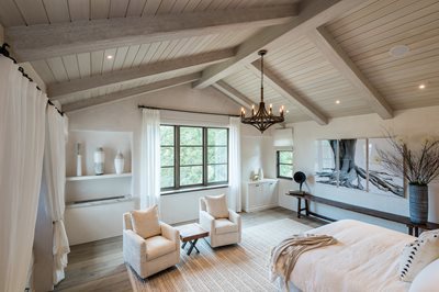 Exposed Beams on Cathedral Ceiling for a Cozy Bedroom
