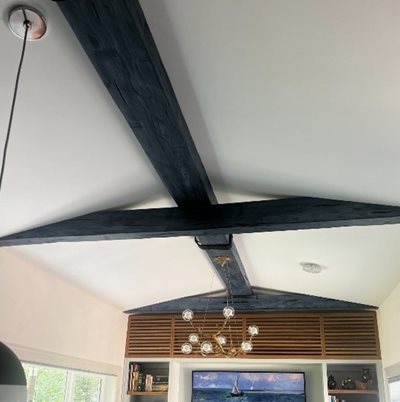 Two large black beams crossing on a ceiling