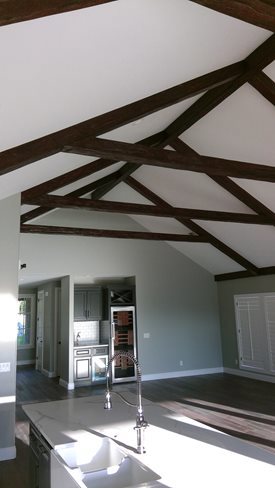 White cathedral ceiling with contrasting beams