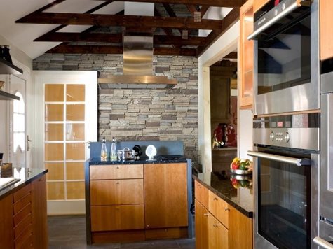 Kitchen with wood beams across an asymmetrical ceiling