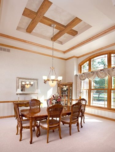 Light brown wood beams crossing on a recessed ceiling